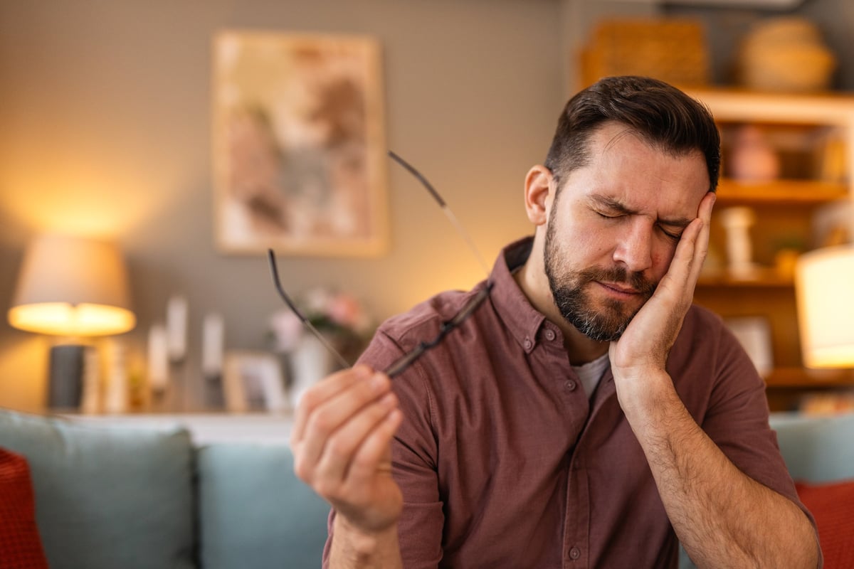 Tooth Pain And Dentistry. Young Man Suffering From Terrible Strong Teeth Pain, Touching Cheek With Hand. Feeling Painful Toothache. Dental Care And Health Concept. High Resolution